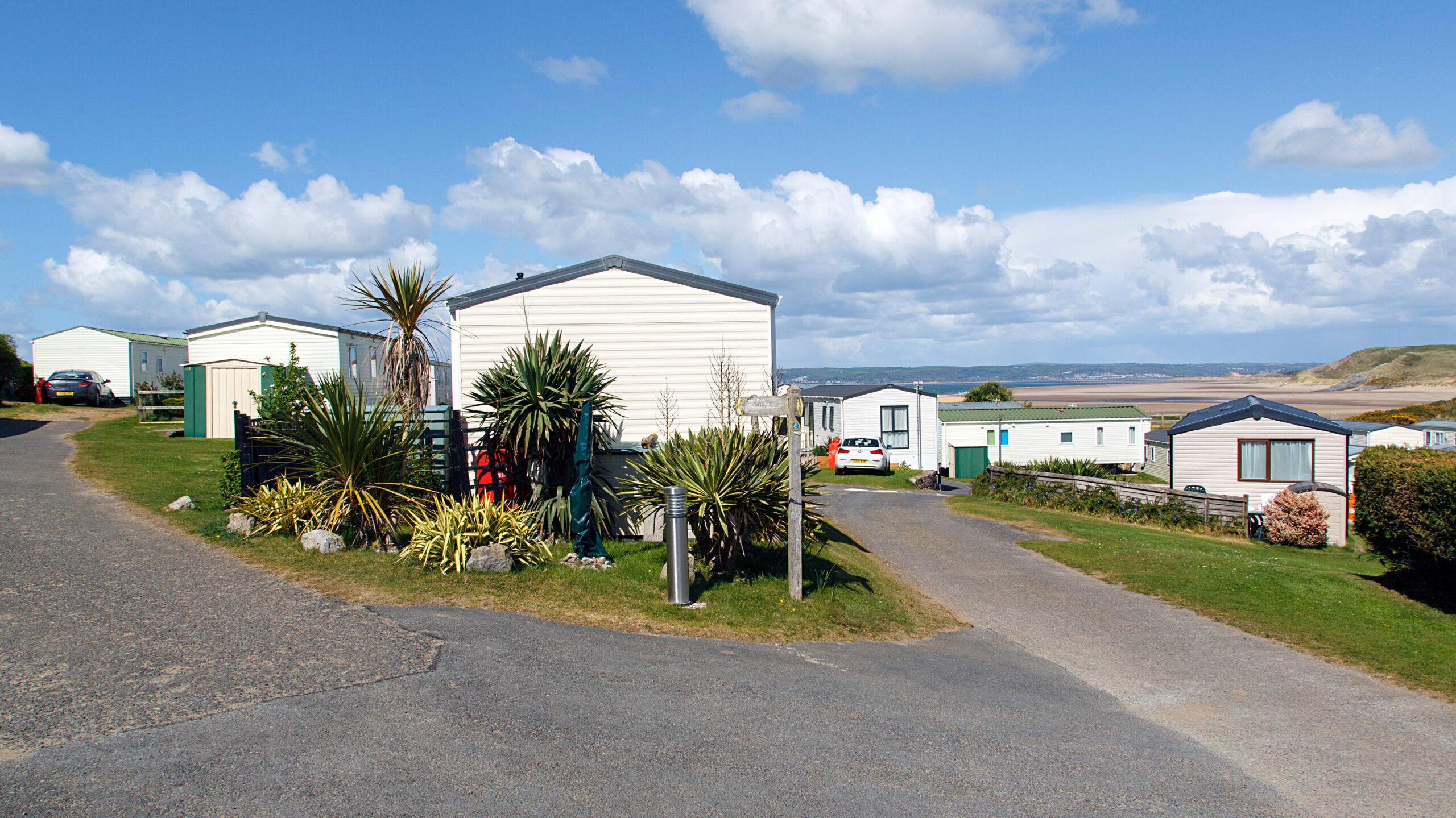 Caravan Park - static caravans in Gower with a panoramic format and a blue sky background.