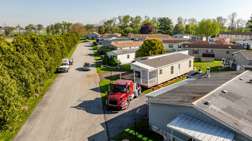 Aerial View of a Manufactured, Mobile, Prefab Double Wide Home Being Installed in a Lot in a Park