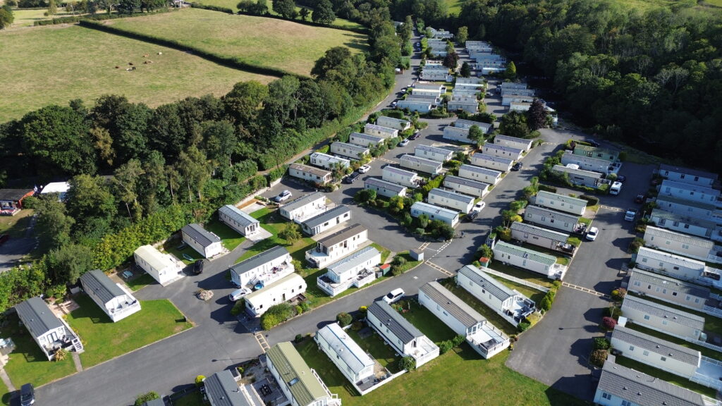 Modern caravan park from above with static homes and countryside views – perfect for tourism, real estate, and lifestyle projects.