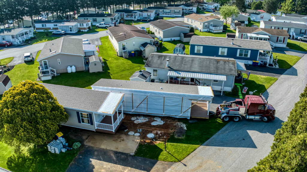 Aerial View of a Manufactured, Mobile, Prefab Double Wide Home Being Installed in a Lot in a Park
